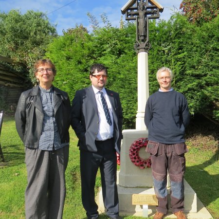 Rev'd Sue Greatorex, Vicar of St Bartholomew's Church at the time of the repairs, Councillor Jonathan Bishop and stone restorer Graham O'Hare standing in front of the newly refurbished memorial